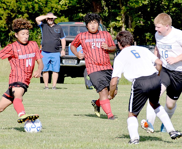 Photo by Rick Peck McDonald County&#8217;s Jeobany Marcos changes direction to avoid two Riverton defenders as teammate Mu Dar looks on during the Mustangs&#8217; 7-1 win over Riverton, Kan. on Aug. 29 at Riverton High School.