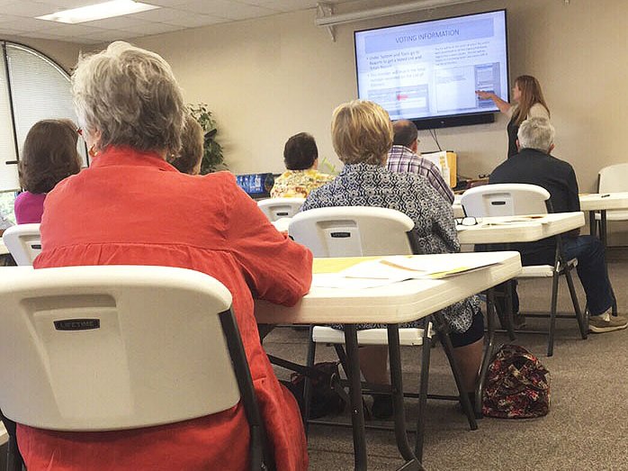 NWA Democrat-Gazette/SCARLET SIMS Poll workers get a refresher Wednesday on election processes from Jennifer Price, Washington County Election Commission executive director, during a training session at the county courthouse in Fayetteville.