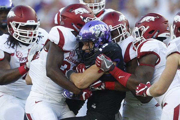 Arkansas defenders tackle TCU quarterback Kenny Hill during a game Saturday, Sept. 10, 2016, in Fort Worth, Texas. 