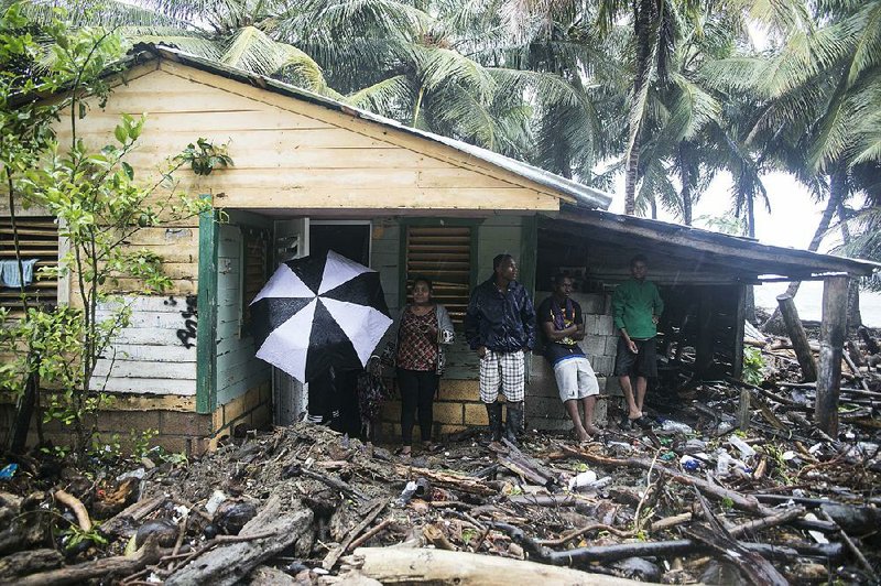 Debris left behind by Hurricane Irma surrounds a home Thursday in Nagua in the Dominican Republic after the Category 5 storm rampaged across the northern Caribbean. 
