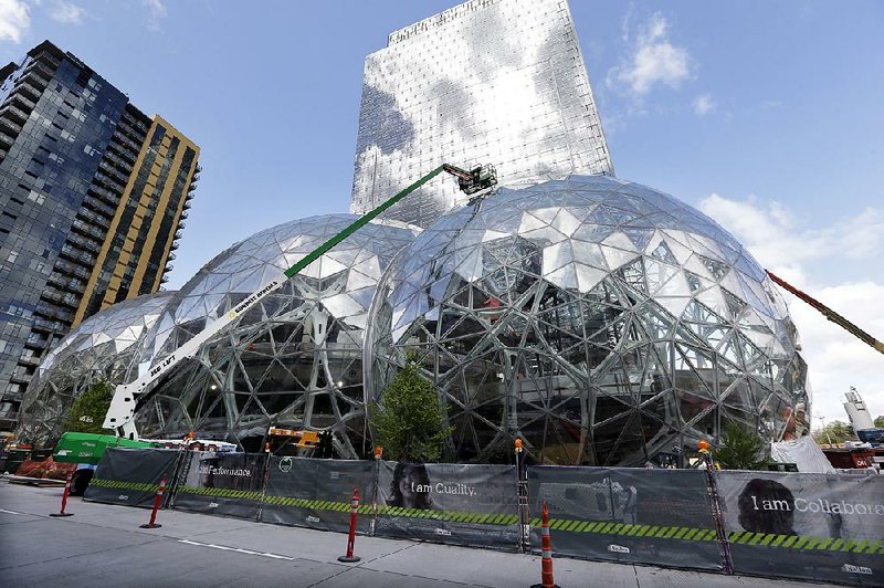 Construction continued earlier this year on three large, glass-covered domes as part of an expansion of the Amazon.com campus in downtown Seattle. Amazon said Thursday that it wants to build another headquarters in North America. 
