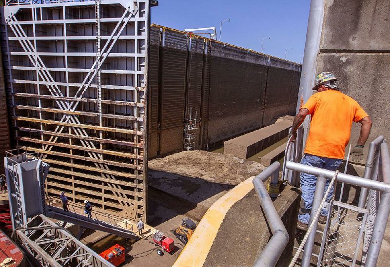 Maintenance personnel work Thursday on the Dardanelle lock, the deepest of the lock chambers in the McClellan Kerr Navigation System along the Arkansas River. The Dardanelle lock maintains a normal water pool level of 54 feet, which holds about 30 million gallons of water.