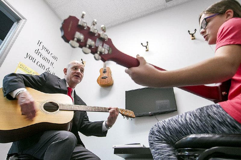 Jim Skelton works with student Alayna Whited on Thursday during one of her vocal and guitar lessons at his music studio in Conway. Skelton, owner and director of the Conway Institute of Music, received the national Music Studio of the Year award during a ceremony Thursday.