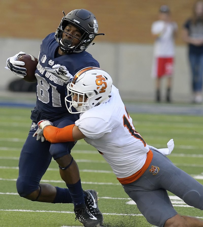 Utah State wide receiver Savon Scarver (81) is tackled by Idaho State defensive back Adkin Aguirre (12) during an NCAA football game Thursday, Sept. 7, 2017, in Logan, Utah. (Eli Lucero/Herald Journal via AP)