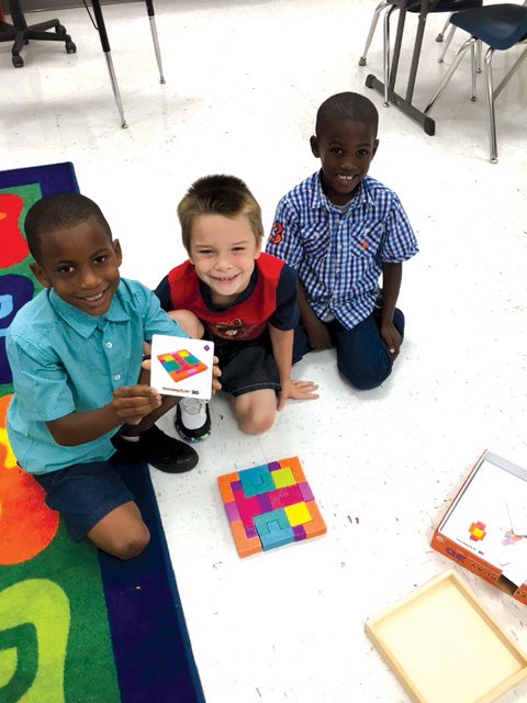 From left, first-grade students Patrick​ Pruitt​, Harley​ Riddle​ and ​Z​a​yve​on ​Smith​ create three-dimensional designs after looking at two-dimensional images in the Science, Technology, Engineering and Mathematics, or STEM, room at Augusta Elementary School.