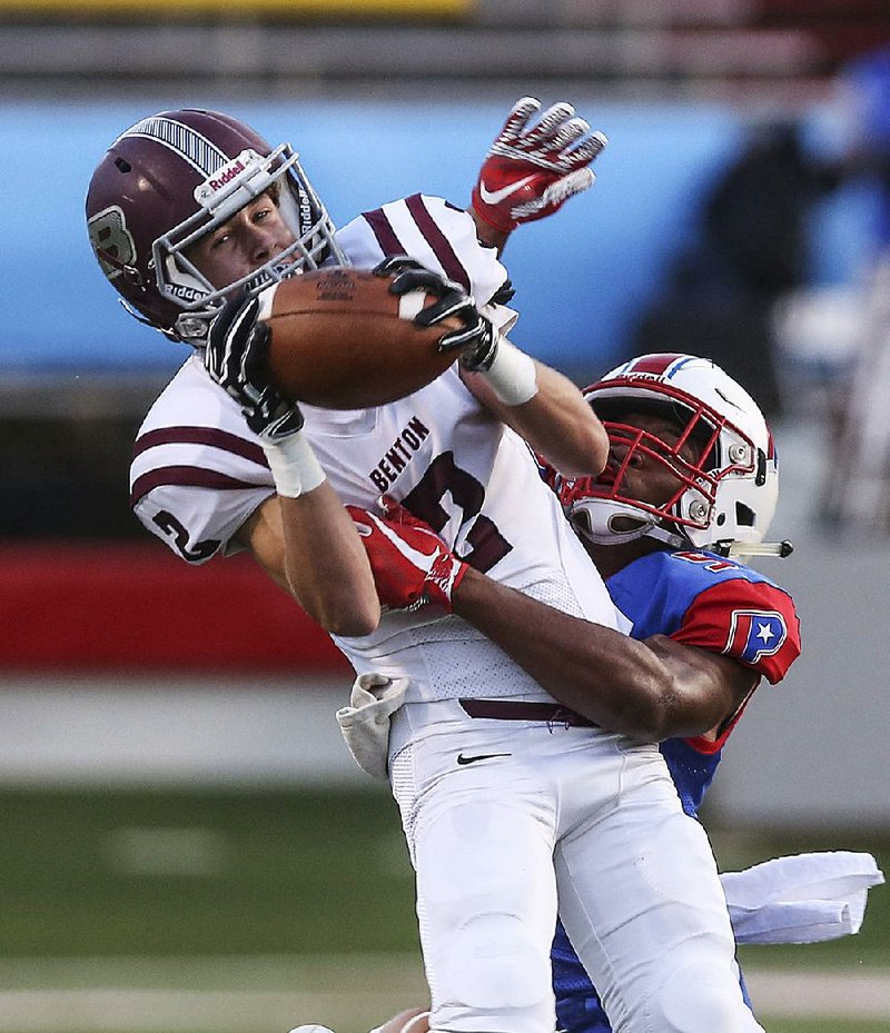 Benton wide receiver Peyton Pallette (2) makes a catch as Little Rock Parkview cornerback Zachery Smith (5) closes in Friday at War Memorial Stadium in Little Rock.