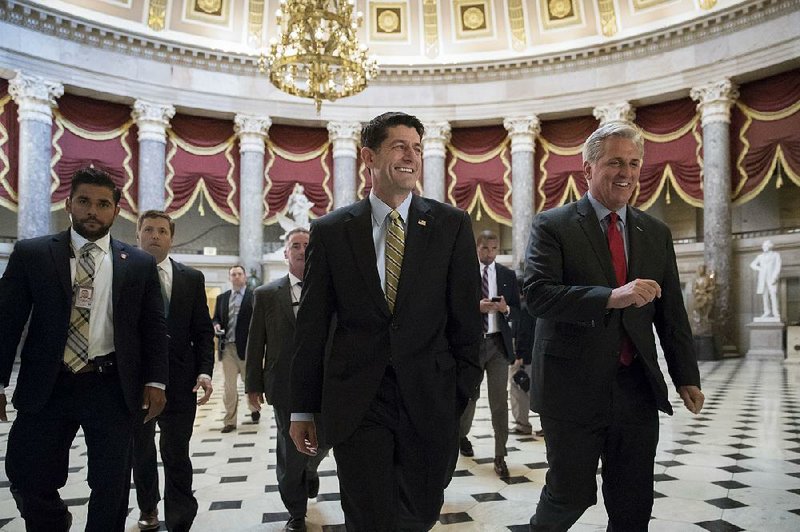 House Speaker Paul Ryan, R-Wis. (center), and Majority Leader Kevin McCarthy, R-Calif., head to the chamber where the House voted Friday to pass the $15.3 billion disaster-aid package. 