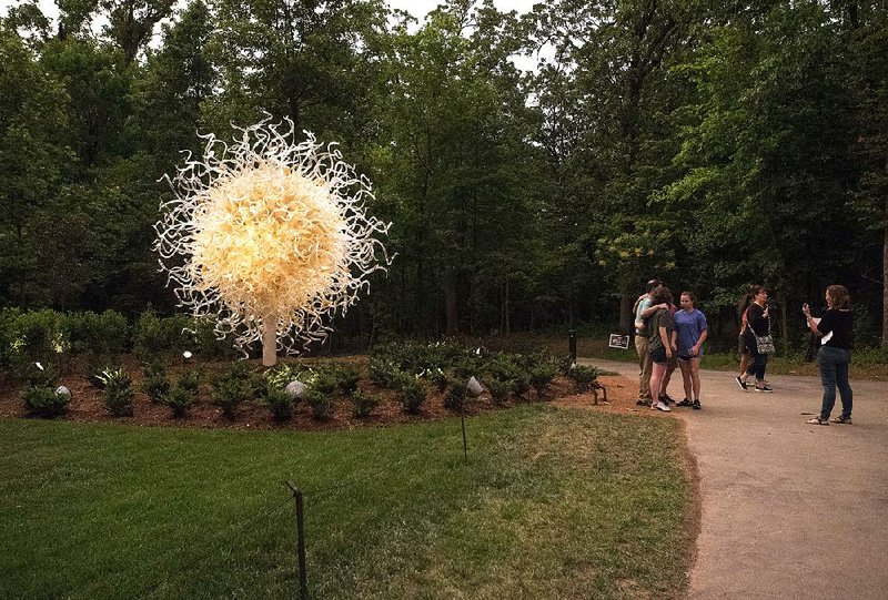NWA Democrat-Gazette/SPENCER TIREY     
Visitors look at "Sole d'Oro," an artwork by Dave Chihuly July 7, 2017, at Crystal Bridges Museum of American Art in Bentonville. 