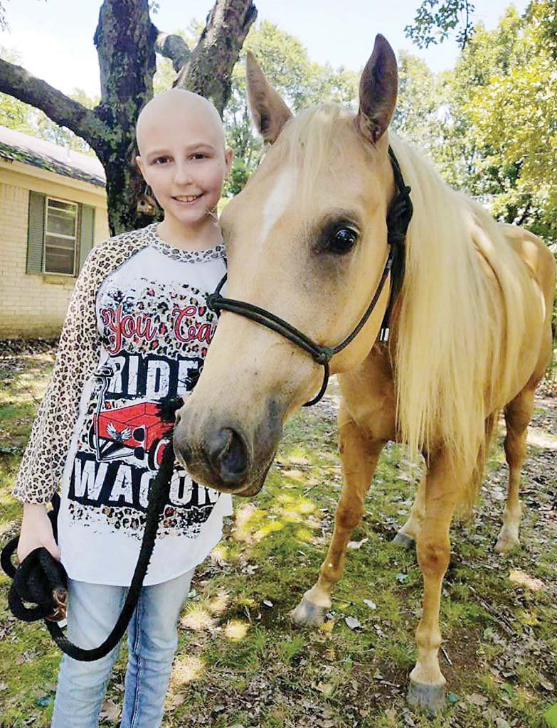 Savannah Westover, 13, stands at her home in Conway with Baby June, a horse from the Wofford Ranch in Vilonia. Savannah was diagnosed in May with osteosarcoma (bone cancer). The Conway High School volleyball team will donate proceeds from Pink Night games on Sept. 28 to Savannah’s family.