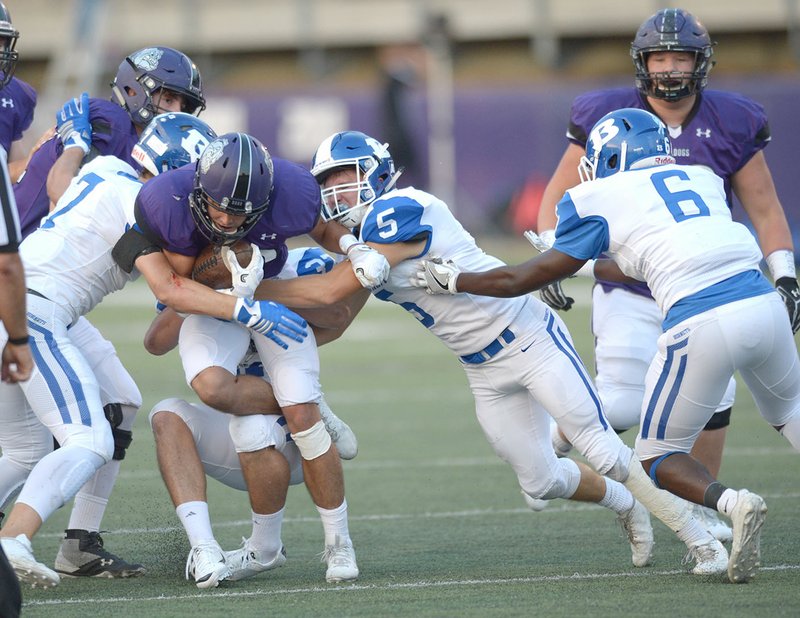 NWA Democrat-Gazette/ANDY SHUPE Fayetteville running back Jackson White (center left) is tackled by Bryant defenders Nick Smith (7), Jakob Neel and Mike Jones (5) on Friday at Harmon Stadium in Fayetteville. Visit nwadg.com/photos for more photos from the game.