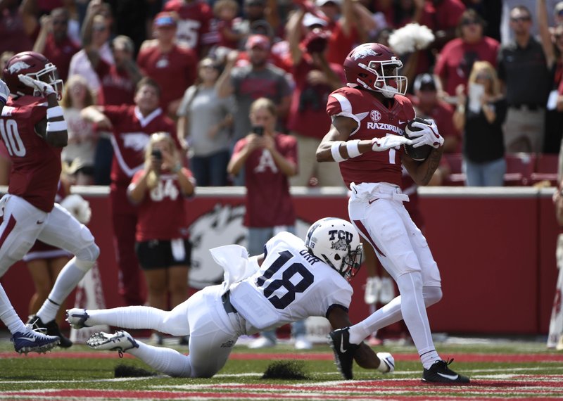 Arkansas receiver Jonathan Nance, right, gets past TCU defender Nick Orr to score a touchdown in the first half of an NCAA college football game in Fayetteville, Ark., Saturday, Sept. 9, 2017. (AP Photo/Michael Woods)

