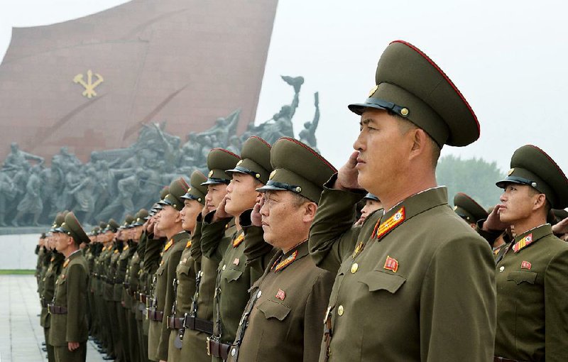 North Korean soldiers salute Saturday in Pyongyang during founding day celebrations in a show of loyalty to late leaders Kim Il Sung and Kim Jong Il, grandfather and father of North Korean leader Kim Jong Un.