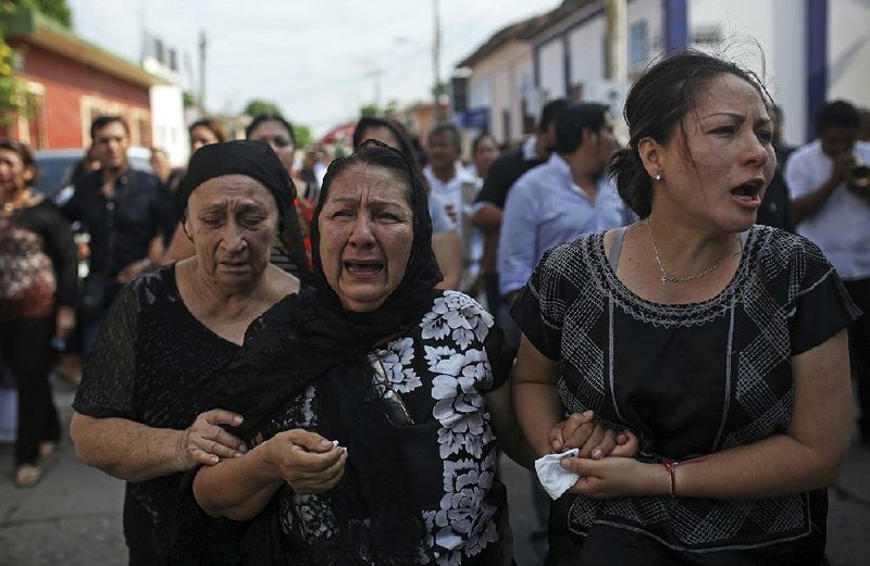 Relatives mourn Saturday at the funeral for 38-year-old earthquake victim German Torres in Juchitan in Mexico’s Oaxaca state.