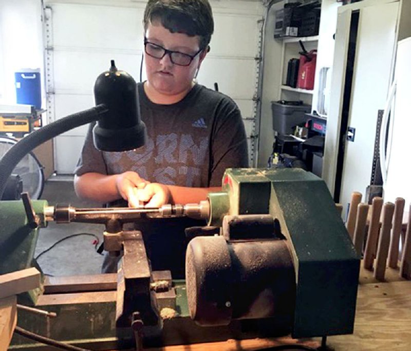 Ramsay Short, 11, of Russellville uses this wood lathe to make the ink pens for his business. 