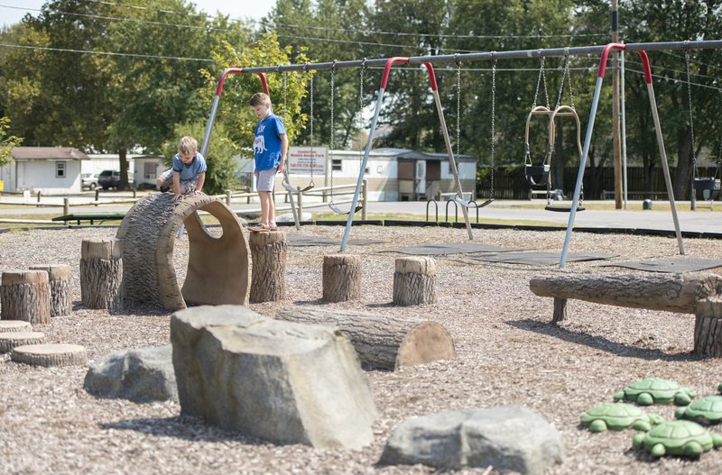 NWA Democrat-Gazette/CHARLIE KAIJO Gavin Lambert (left), 3, and Phoenix Lambert, 5, of Bella Vista play Friday at the park at Centerton's City Hall. Residents will decide Tuesday if they want to extend a one-cent sales tax to pay for road improvement, park development and a new city hall.