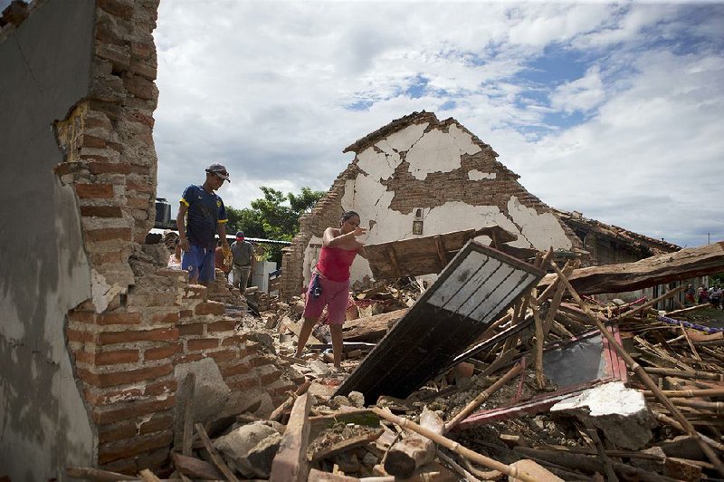 A woman on Sunday removes debris from what remains of her home, which was destroyed in Thursday’s magnitude-8.1 earthquake, in Union Hidalgo, Oaxaca state, Mexico.