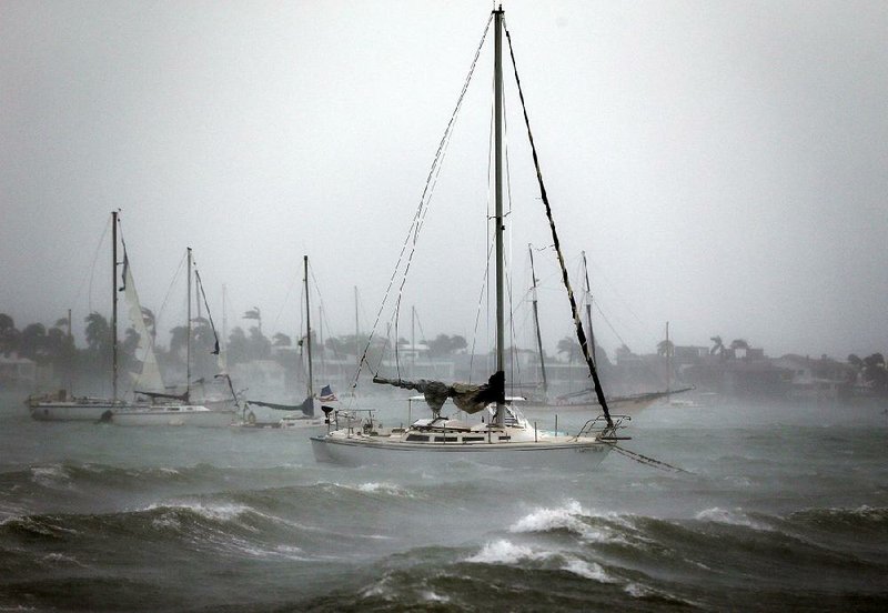 Sailboats moored near Watson Island ride out the winds and waves as Hurricane Irma passes Sunday in Miami Beach, Fla.