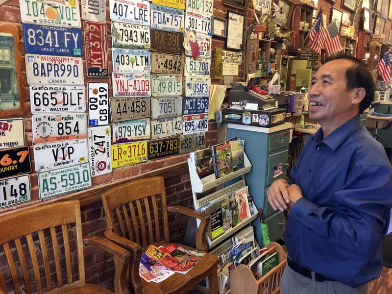 In this Sept. 6, 2017, photo, Anthony Pham, talks in his Monroe, Ga., barber shop. He became a U.S citizen in 1987, five years after he immigrated from Vietnam.  Now a business owner and proud Republican in Georgia&#x2019;s staunchly conservative 10th Congressional District, Pham says he supports maintaining legal status for immigrants who arrived in the country illegally as children, the so-called &#x201c;Dreamers&#x201d; brought by adult family members. (AP Photo/Bill Barrow)