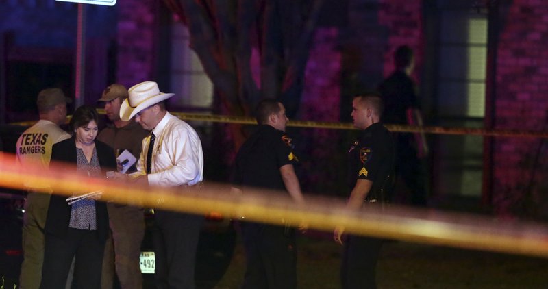 Law enforcement officers and investigators gather outside the scene of a shooting in Plano, Texas, Sunday, Sept. 10, 2017. Authorities in North Texas say several people are dead, including the suspect, after a shooting at the Plano home. (AP Photo/LM Otero)

