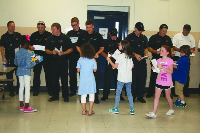 Thanks: During a Patriot Day assembly, Northwest Elementary students thank local first responders with handwritten notes and drawings.