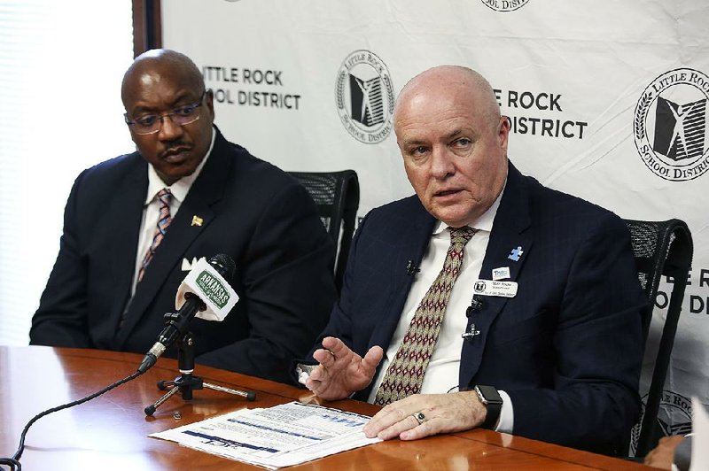 Little Rock School District Superintendent Mike Poore talks to the media about a settlement between the school system and parents. Deputy Superintendent Marvin Burton is at left.