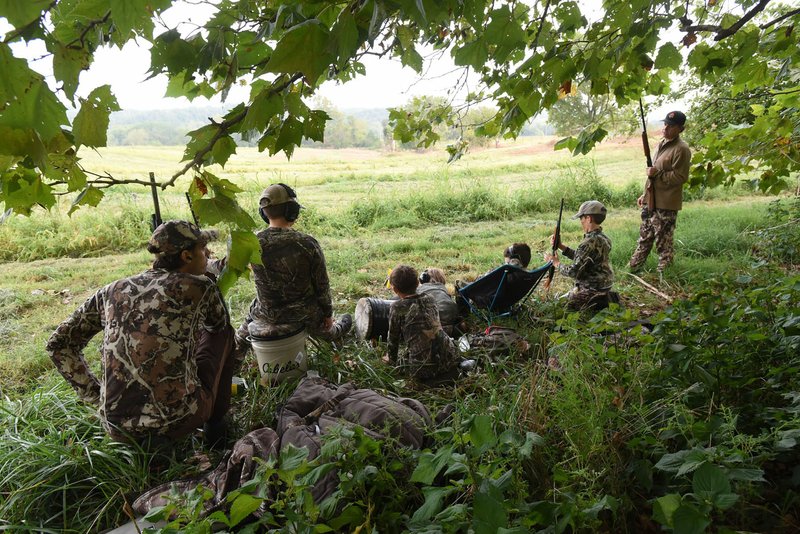 Jeremy Wilson (left) and Chad Yoes (right) hunt with their sons on opening day of Arkansas’ dove season, Sept. 2. The dads used the hunt to teach the boys about nature and wildlife, and also English, math and other subjects they study in school.