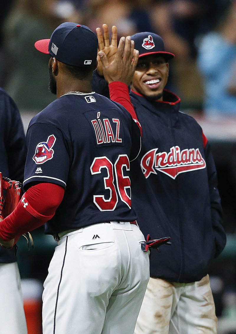 Cleveland Indians' Francisco Lindor, right, and Yandy Diaz (36) celebrate a 11-0 victory over the Detroit Tigers in a baseball game, Monday, Sept. 11, 2017, in Cleveland. 