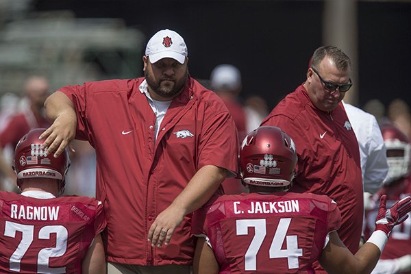 Arkansas offensive line coach Kurt Anderson, left, and head coach Bret Bielema talk with players prior to a game against TCU on Saturday, Sept. 9, 2017, in Fayetteville. 