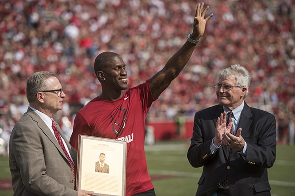 Former Arkansas safety Ken Hamlin, center, receives his UA Hall of Honor plaque from UA athletics director Jeff Long, left, during halftime of a game against TCU on Saturday, Sept. 9, 2017, in Fayetteville. 