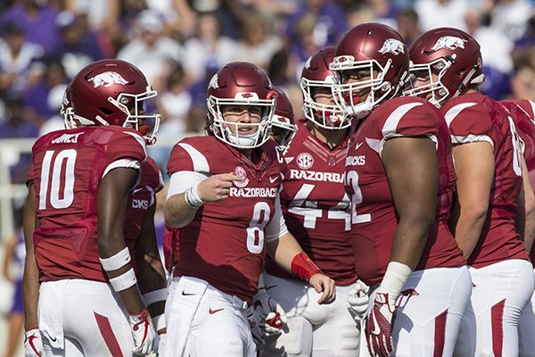 Arkansas quarterback Austin Allen (8) looks toward the sideline while huddling with teammates during a game against TCU on Saturday, Sept. 9, 2017, in Fayetteville. 