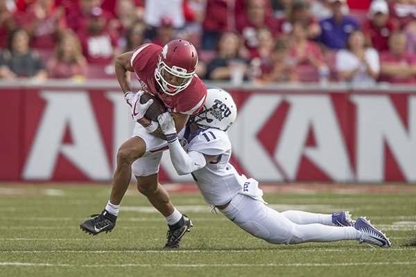 Arkansas receiver Deon Stewart is tackled by TCU defensive back Ranthony Texada during a game Saturday, Sept. 9, 2017, in Fayetteville. 