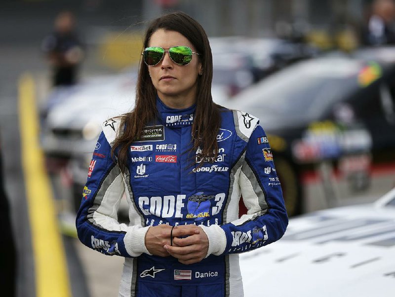 In this Thursday, May 25, 2017 file photo, Danica Patrick stands by her car before qualifying for Sunday's NASCAR Cup series auto race at Charlotte Motor Speedway in Concord, N.C. 