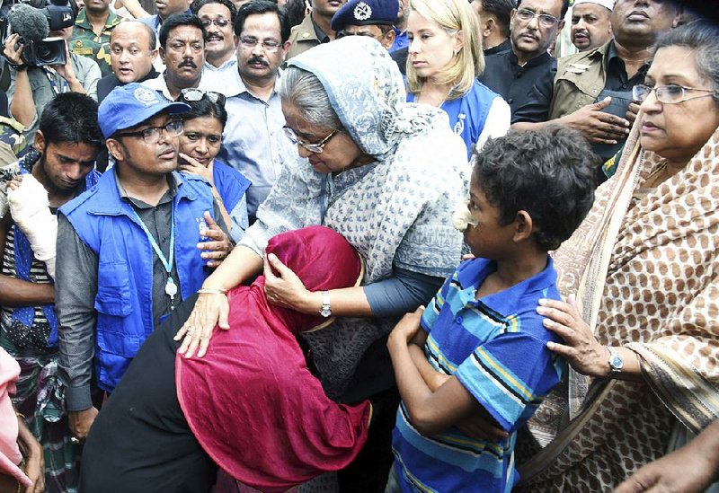 Bangladeshi Prime Minister Sheikh Hasina (center) meets with Rohingya Muslims on Tuesday at Kutupalong refugee camp near the border town of Ukhia, Bangladesh. 