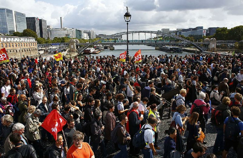 Protesters march against President Emmanuel Macron’s new pro-business labor policies Tuesday in Paris. 
