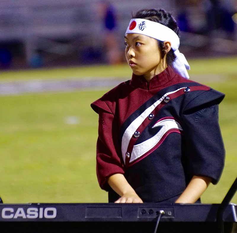 Photo by Randy Moll Alexia Lo plays the keyboard during the halftime performance of the Gentry High School marching band in Pioneer Stadium on Friday, Sept. 1.