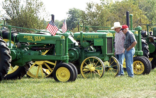 Photo by Randy Moll Larry Keaton and Kenneth Christerson of Anderson, Mo., were involved in tractor talk at the fall show of the Tired Iron of the Ozarks on Friday, Sept. 8, 2017. The featured tractor at this year&#8217;s show was the John Deere and there were plenty of the old tractors to show off. The antique engine and tractor show ran through Sunday.