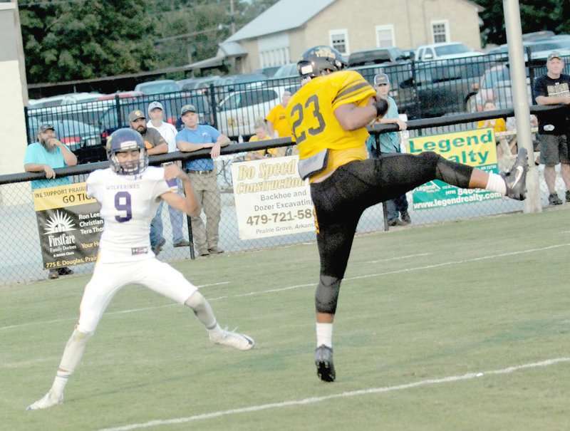 MARK HUMPHREY ENTERPRISE-LEADER Prairie Grove senior DeMarcus Cooper comes down with J.D. Elder&#8217;s touchdown pass against Vian, Okla., Friday. Cooper caught three passes for 42 yards. The Tigers prevailed, 41-21.