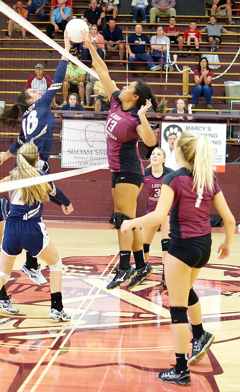 Photo by Randy Moll With Madison Ward and Madison Stanfill at the ready, Gentry&#8217;s Chastery Fuamatu battles at the net against a Shiloh Christian player during Gentry&#8217;s Sept. 7 home game. The Gentry girls put up a strong fight but lost the match in three sets.
