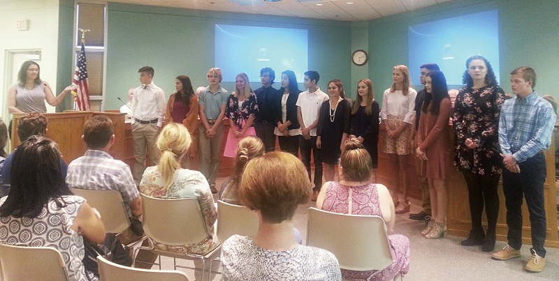 NWA Democrat-Gazette/HICHAM RAACHE Melissa Reeves (left), Springdale's public relations director, introduces Springale's first Youth Council class during the City Council meeting on Tuesday. The council is made up of 18 high school students.