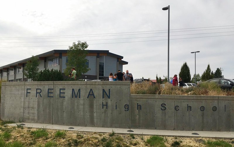 People gather outside of Freeman High School after reports of a shooting at the school in Rockford, Wash.,  on Wednesday, Sept. 13, 2017. 
