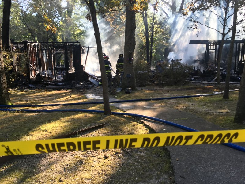 Firemen clean up a home on Haven Drive deemed a total loss Wednesday, September 13, 2017 after responding to the house fire at 3:38 a.m. Officials reported one confirmed fatality. Beaver Lake, Rocky Branch, Piney Point and Rogers fire departments responded to the fire.