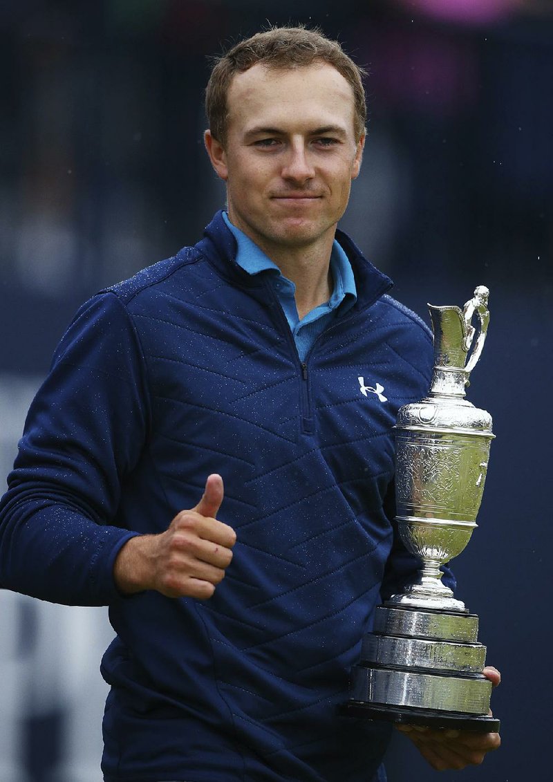 This July 23, 2017, file photo shows Jordan Spieth of the United States holding the trophy after winning the British Open Golf Championships at Royal Birkdale, Southport, England. 