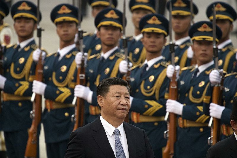 Chinese President Xi Jinping reviews an honor guard Wednesday in Beijing. Former White House chief strategist Stephen Bannon said in Hong Kong that President Donald Trump has great respect for Xi. 