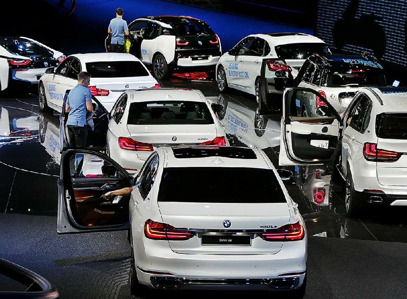 Drivers settle into BMW vehicles on display Wednesday at an auto show in Frankfurt, Germany. 