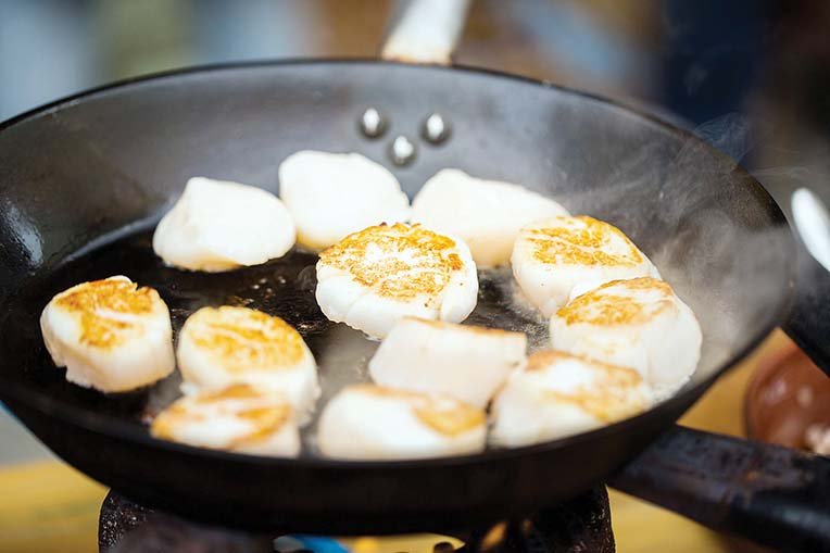 Briefly sear the scallops before coating them in the teriyaki glaze.