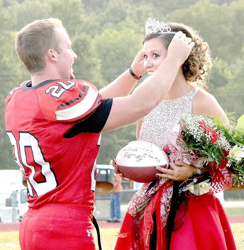 Photo by Rick Peck Senior football captain Jake Will crowns 2016 football homecoming queen Journey Sanny.