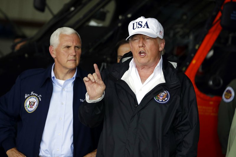 President Donald Trump and Vice President Mike Pence, left, participate in a briefing on the Hurricane Irma relief efforts Thursday, Sept. 14, 2017, in Ft. Myers, Fla., at Southwest Florida International airport. 