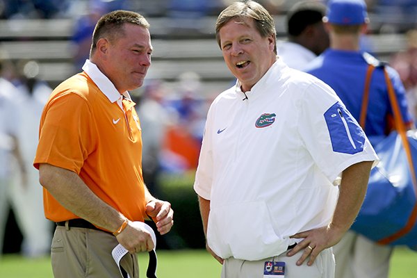Tennessee head coach Butch Jones, left, and Florida head coach Jim McElwain chat at midfield before an NCAA college football game, Saturday, Sept. 26, 2015, in Gainesville, Fla. (AP Photo/John Raoux)
