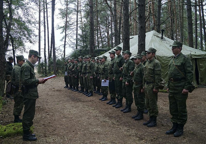Belarus Col. Alexander Prokopenko (left) delivers his order Thursday to start war games with Russian forces at an undisclosed site in Belarus. After the exercise began, Russia announced that a tank unit has been “put on alert” and moved into Belarus, with airborne troops also standing by.  
