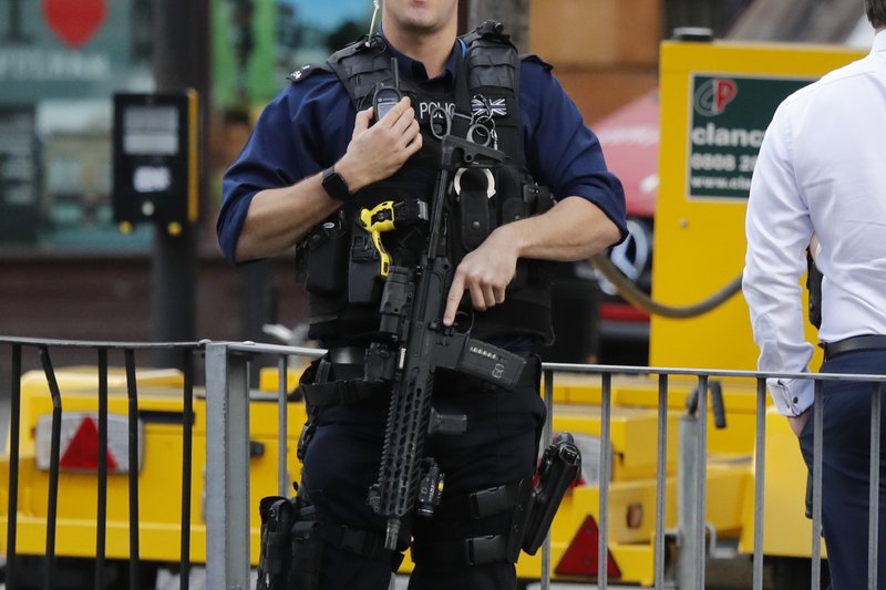 An armed police officer stands nearby after an incident on a tube train at Parsons Green subway station in London, Friday, Sept. 15, 2017. A reported explosion at the train station sent commuters stampeding in panic, injuring several people on Friday at the height of London's morning rush hour, and police said they were investigating it as a terrorist attack. (AP Photo/Frank Augstein)
